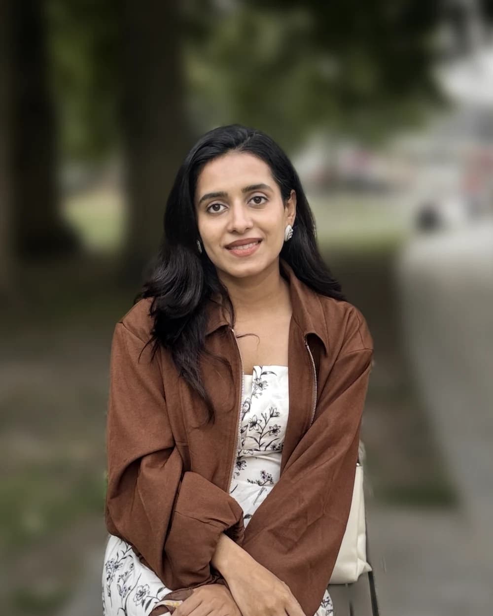 Nimra Zahid, International Relations researcher and educator, seated on a park bench